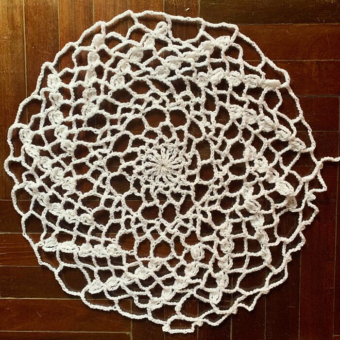 Intricate white crochet doily showcasing talented crocheters' skills
