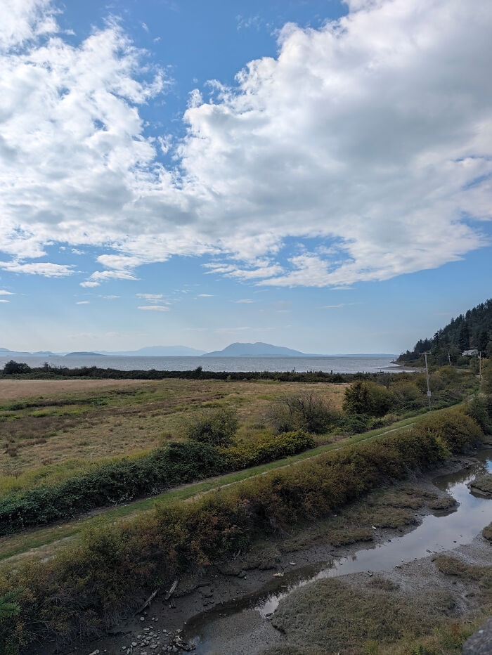 Leukemia survivor granddaughter walking 356 miles with scenic coastal landscape and cloudy sky
