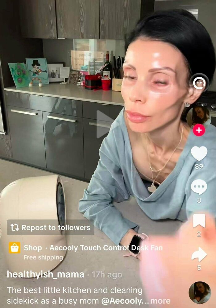Influencers filming a product promo video using a desk fan inside a modern kitchen content studio