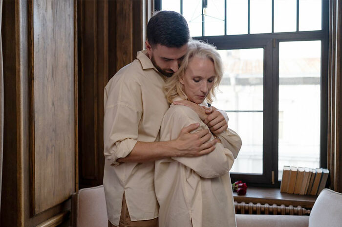 A young man comforting an older woman, showing how relationships changed after marriages collapsed.