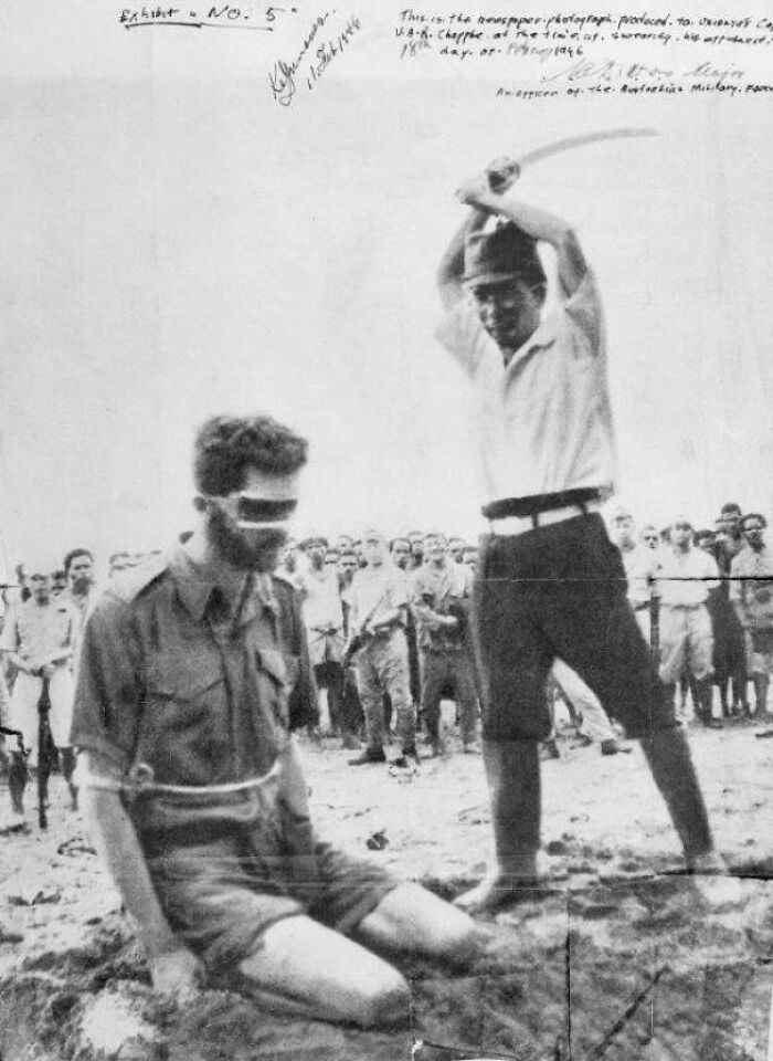 Historical photo of a blindfolded prisoner captured in photos for the last time before e*******n