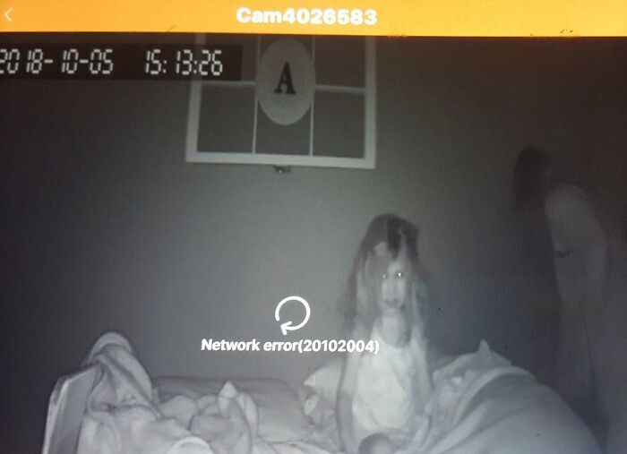Eerie night-vision camera footage of a child in bed looking like a scene straight out of a horror movie