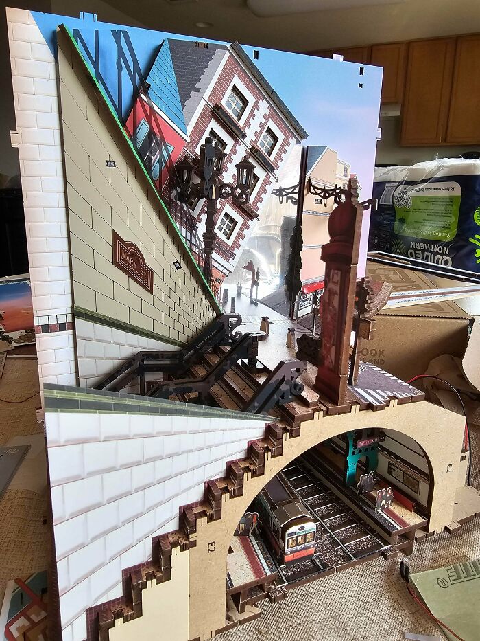 A detailed subway station and city street book nook kit showing forced perspective architecture.
