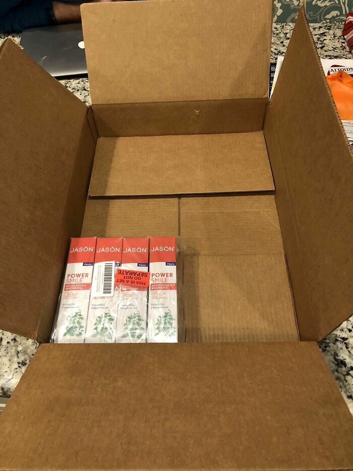 Small toothpaste pack inside a huge cardboard box, illustrating packaging fails.