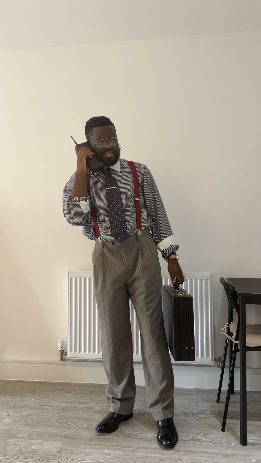Man wearing 80s stockbroker outfit with brick phone as creative Halloween costume idea