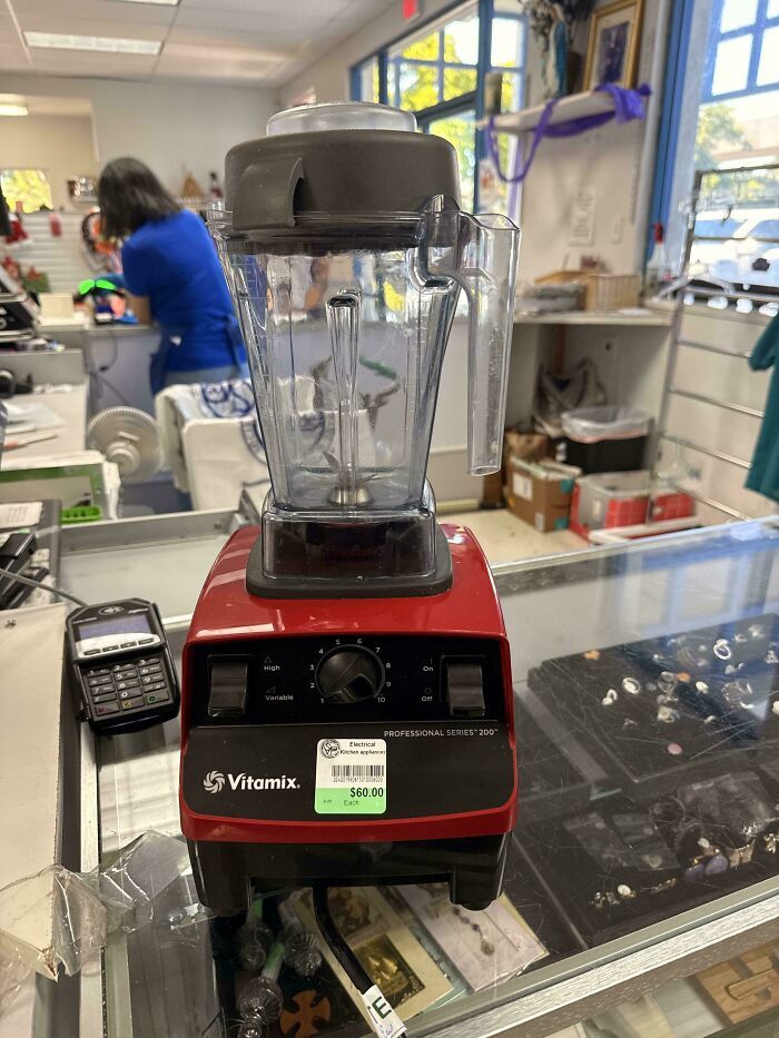 A red Vitamix professional blender sitting on a counter, a lucky thrift store find