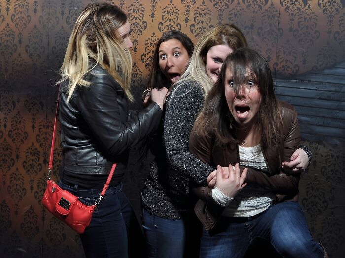 Group of frightened women in a haunted house photo screaming in fear