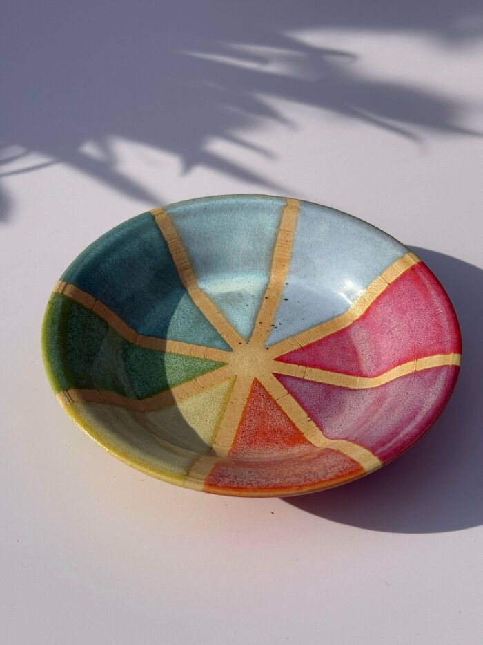 A colourful ceramic dish with a pinwheel design displaying unique pottery creations