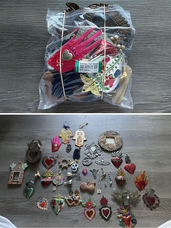 A bag and spread of metal ornaments showing eclectic thrift store finds on a wooden floor