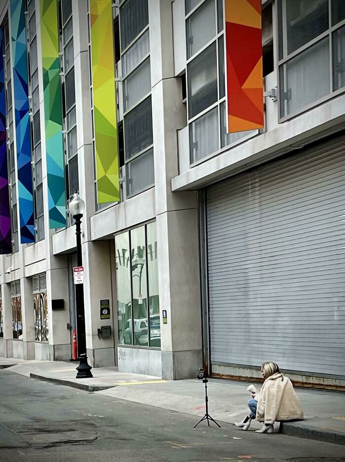 Influencers in public spaces using a phone tripod on a city sidewalk
