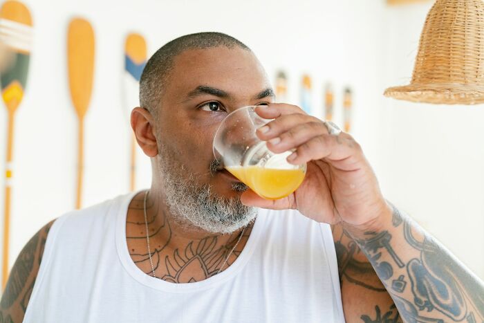 Man drinking juice while dealing with marriages collapsed