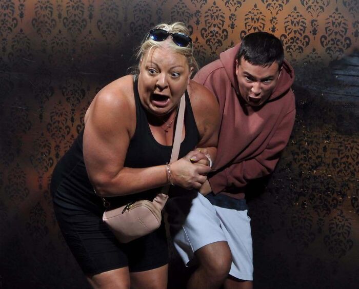 Terrified couple captured in a funny haunted house photo reacting with shocked expressions
