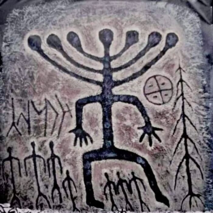 Ancient cave painting depicting a large central figure and smaller human forms, revealing cool facts about the past.