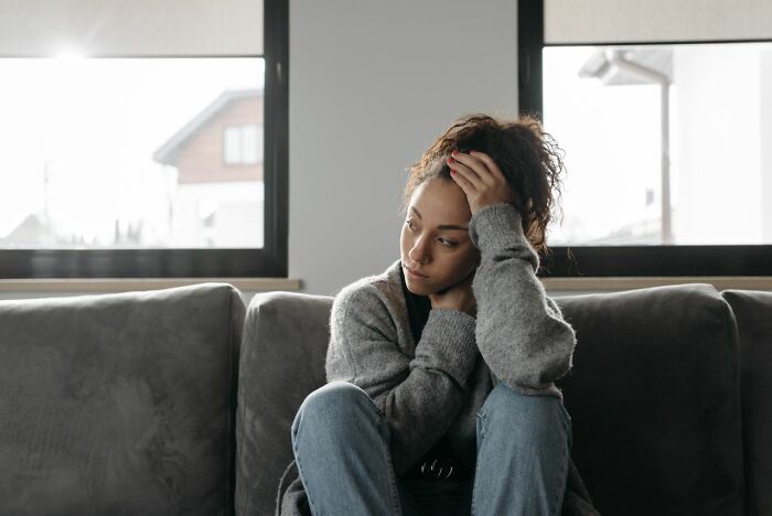 Sad woman on a couch showing a sign of marriages collapsed