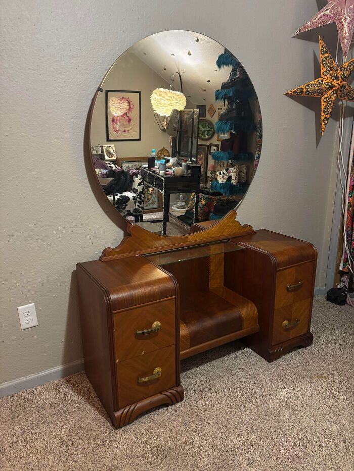 A vintage wooden vanity dressing table with a large round mirror, a great secondhand find.