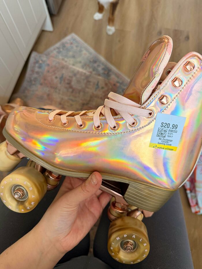 A hand holding a holographic roller skate with a thrift store price tag, showcasing unique secondhand finds.