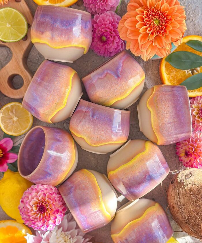 A set of colorful ceramic tumblers with pink and yellow glazes representing beautiful pottery creations