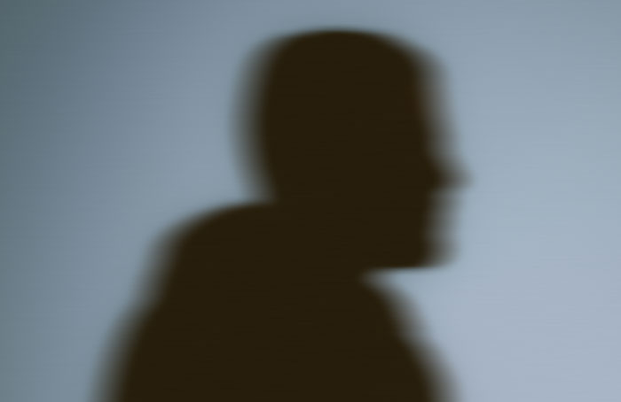 A shadowy silhouette of a figure, evoking a dark mood fit for Halloween stories.