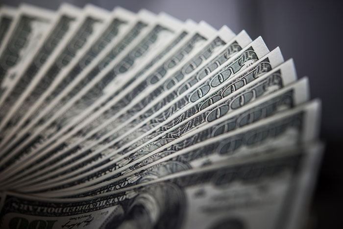 Fanned out stack of US hundred dollar bills representing financial settlements in divorce stories.
