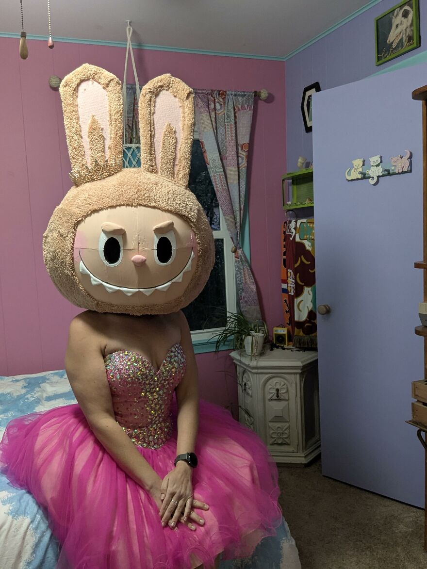 A person wearing a pink gown and a giant bunny head for creative Halloween costume ideas.