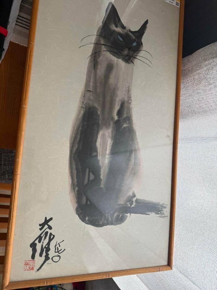 A framed watercolor painting of a Siamese cat, found while looking for thrift store finds