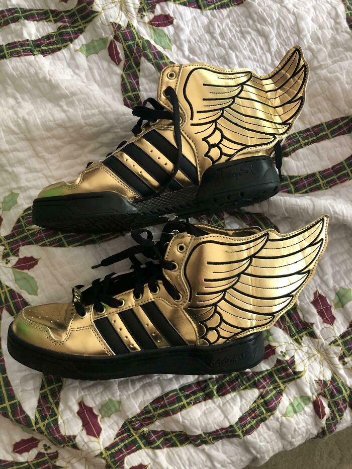 Pair of metallic gold high-top sneakers with wings, found as unique thrift store finds