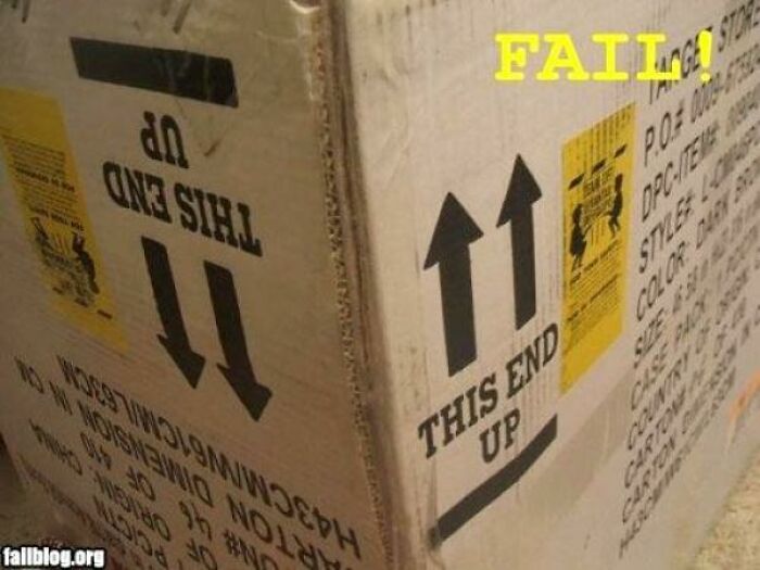 Cardboard shipping box with upside-down 'This End Up' labels, showing bad packaging fails.