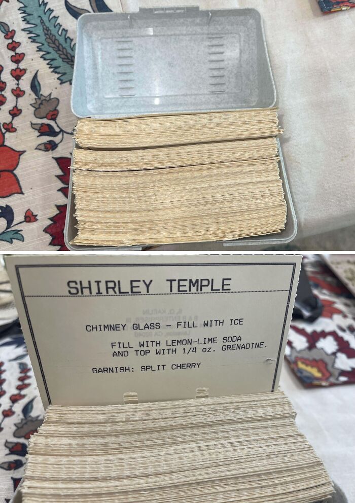 A vintage cocktail recipe card index in a grey plastic box, showing thrift store finds.