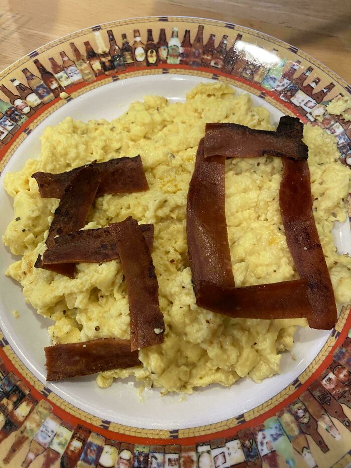 Scrambled eggs and bacon spelling out fifty highlighting husband quirks
