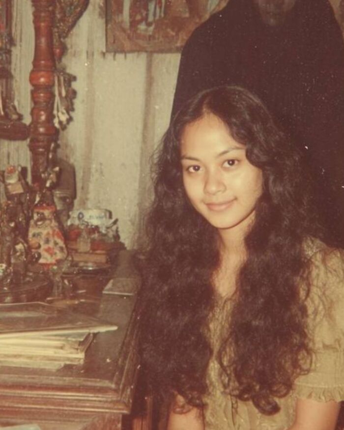 Creepy vintage real-life photo of a smiling woman with a dark shadow figure like a horror movie