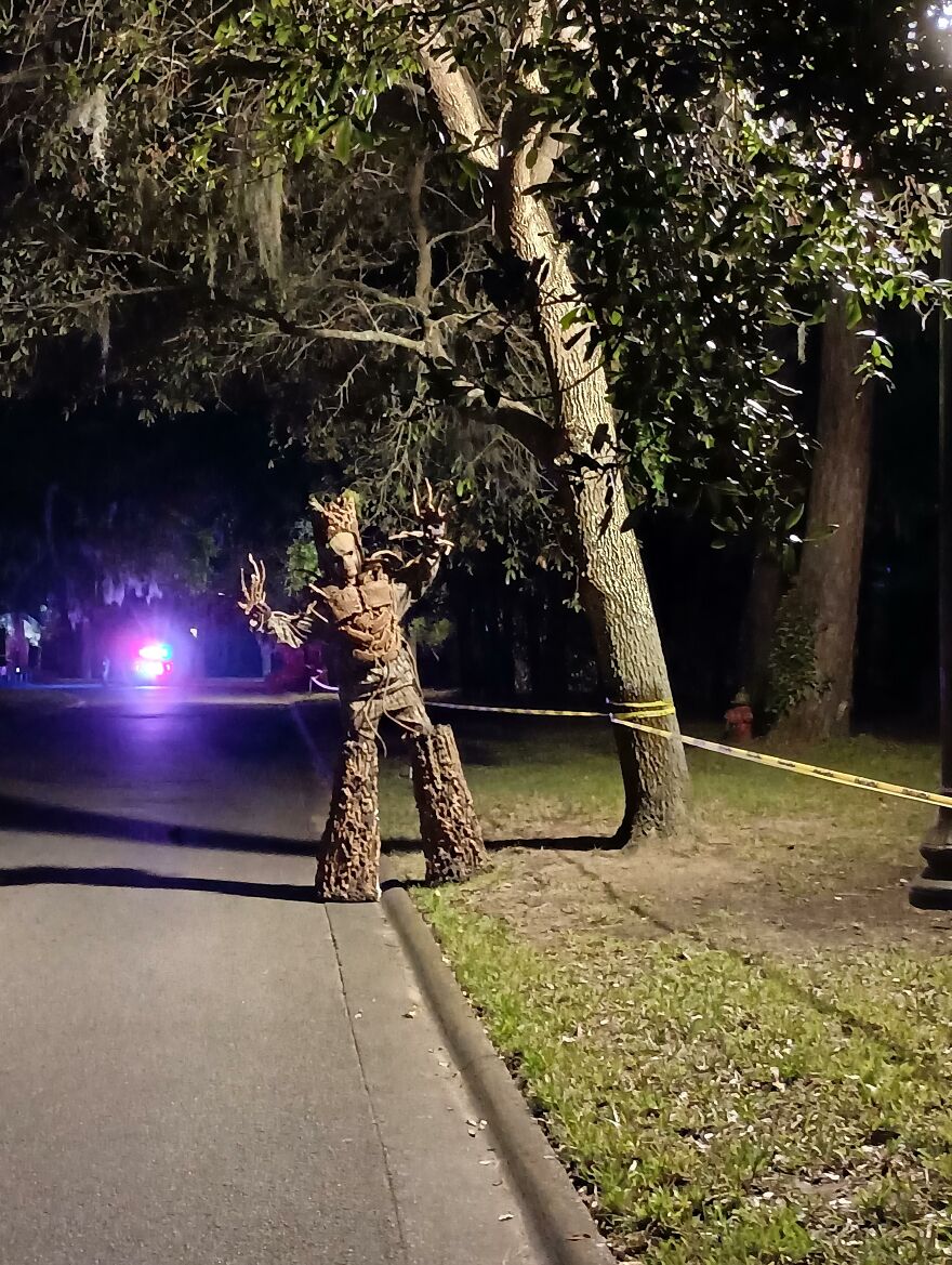 Tall tree-like monster on stilts outside as a creative Halloween costume idea.
