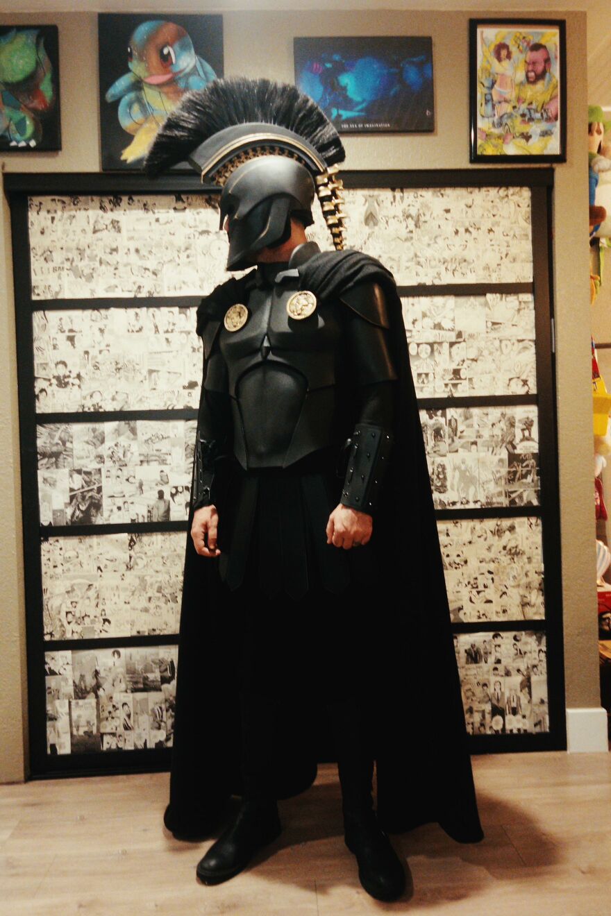 A person in full black Spartan warrior armor, displaying a creative Halloween costume idea.