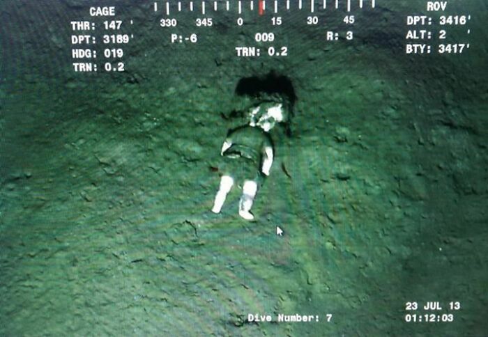 Mannequin or statue discovered at the bottom of the ocean on a deep dive camera feed.