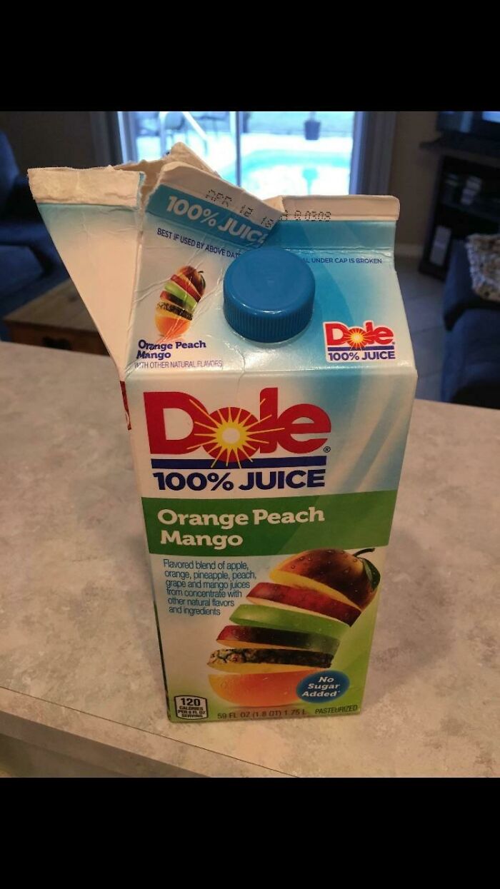 A poorly opened carton of juice, illustrating funny husband quirks in a kitchen.