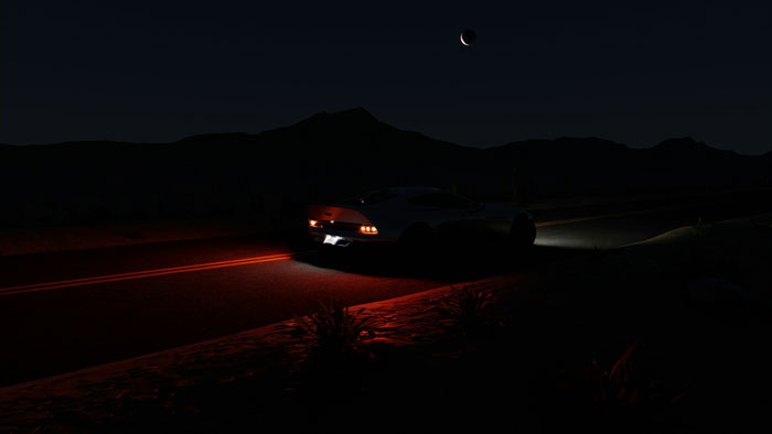 A car driving down a dark desert road at night, setting a scene for creepy Halloween stories.