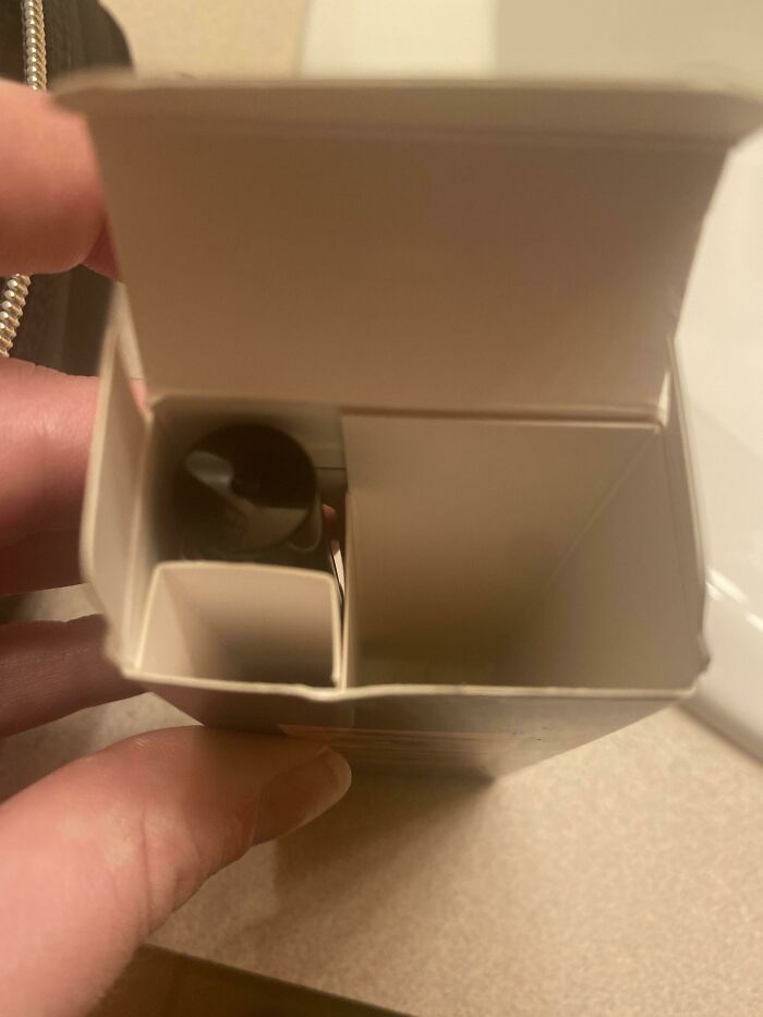 Mostly empty product box with a large internal divider holding a small item, reflecting bad packaging fails.