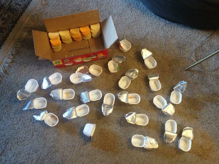 Excessive plastic containers spilled out of cardboard box displaying packaging fails
