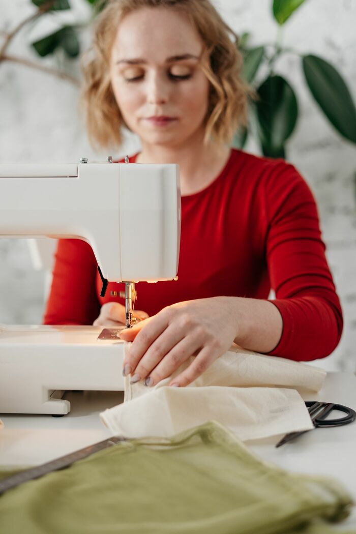 Woman focused on sewing with a machine, creating new relationship revenge stories