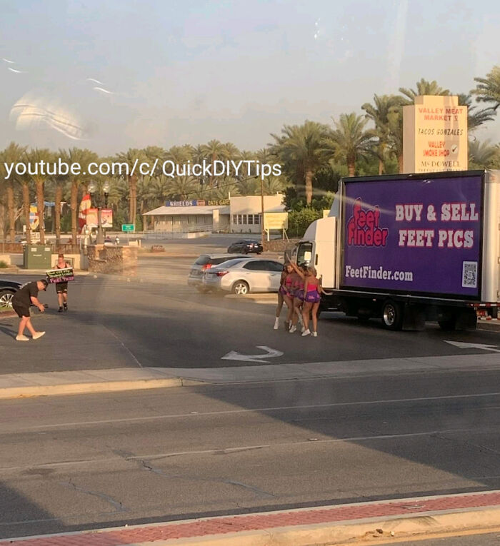 Group of influencers filming content next to a mobile advertisement truck in a parking lot.