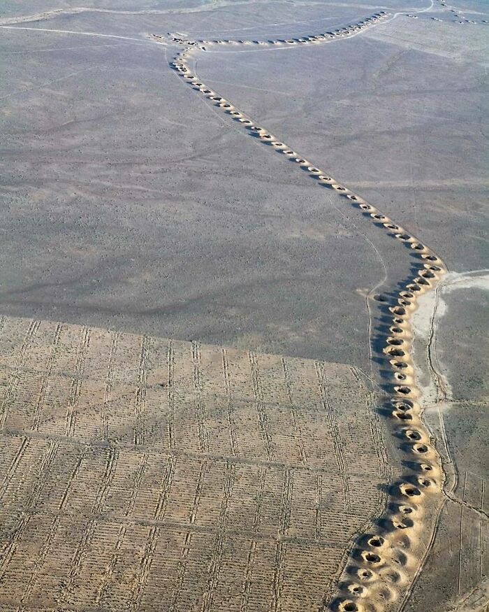 Aerial view of ancient underground aqueduct holes showing cool history in the desert.