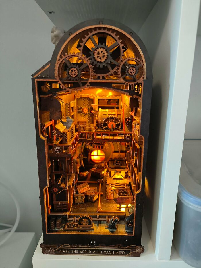 Steampunk industrial factory book nook miniature with turning gears and warm yellow lighting