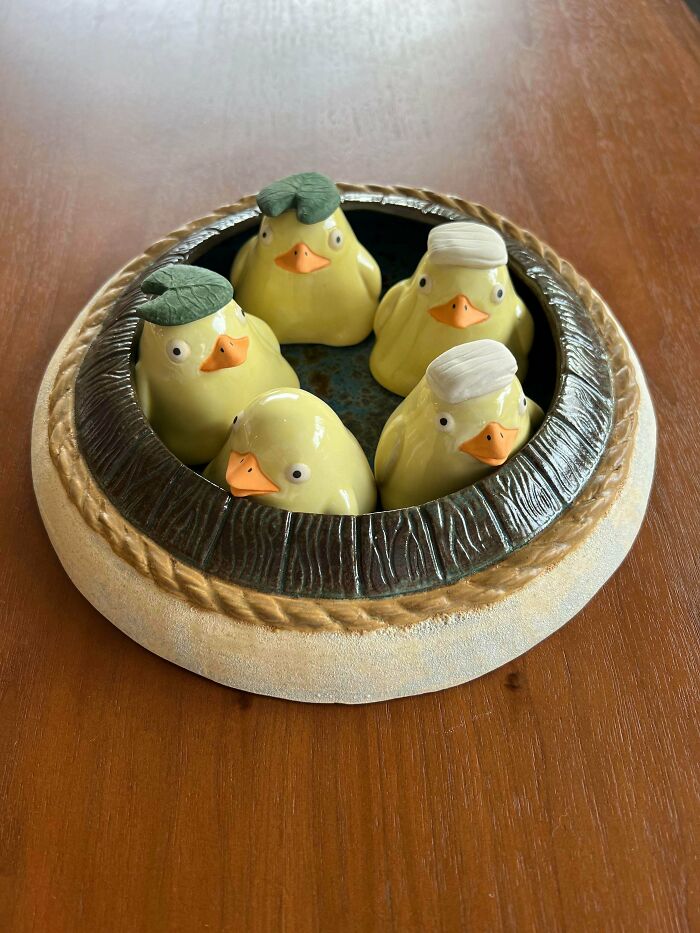 Cute ceramic ducklings bathing in a tub as part of creative pottery creations