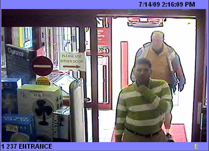 Security camera footage showing a person captured in photos at a store entrance.