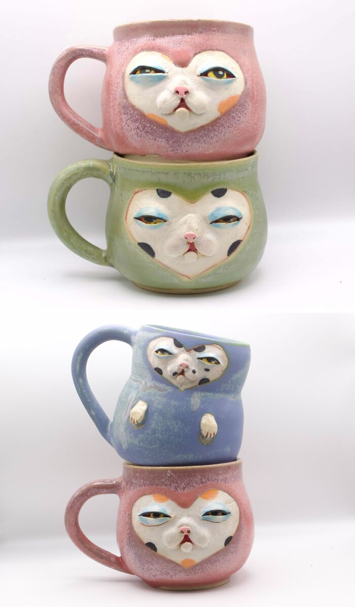 Stacked colorful ceramic mugs featuring whimsical cat faces from unique pottery creations.