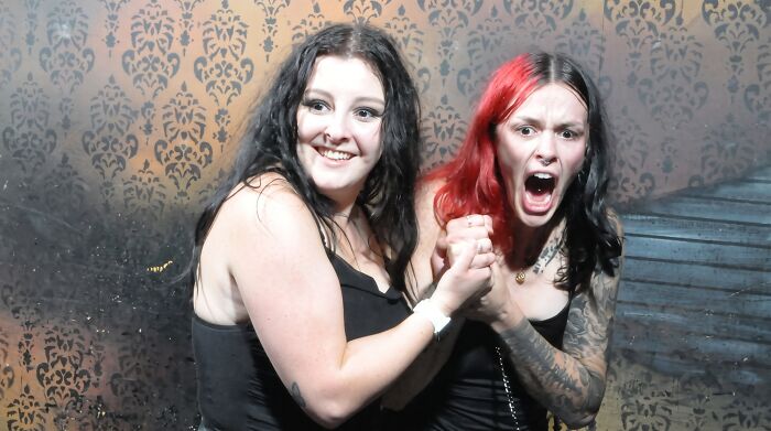 Two young women reacting with shock and screams in haunted house photos