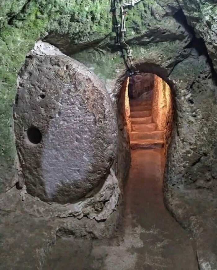 Underground stone door blocking a passageway, showcasing interesting facts about the past.