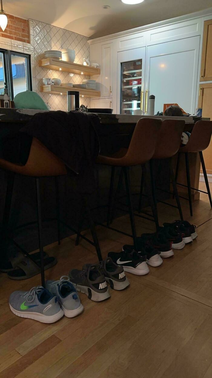 Husbands funny quirks show multiple pairs of similar athletic shoes lined up.