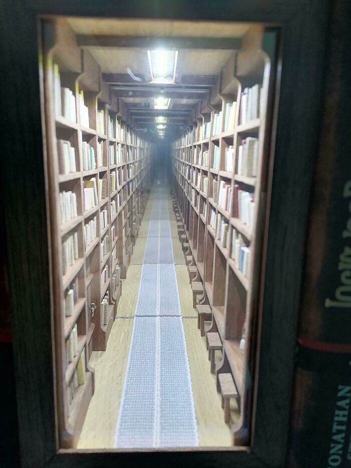 An infinite library book nook with endless rows of bookshelves reflecting in a mirror