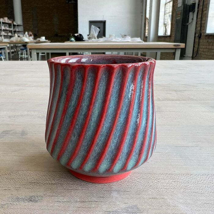 Red and blue striped ceramic vessel showcasing unique pottery creations