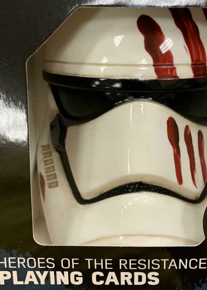 Close-up of a mask toy inside a box, showing bad packaging design.